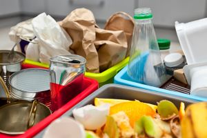 waste separated into different coloured bins, glass, paper, plastic and food waste